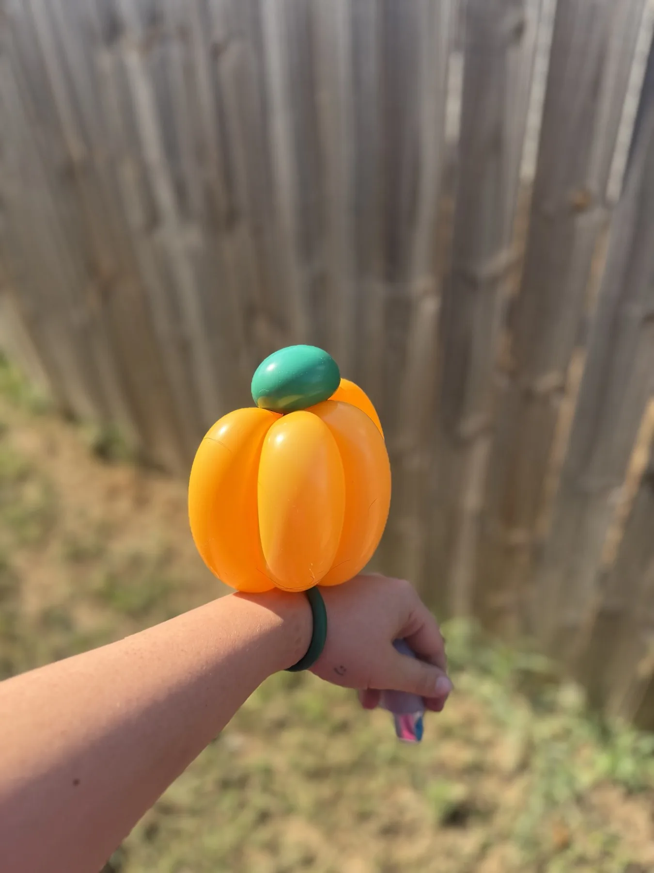 Orange pumpkin balloon bracelet made for a Texas fall event