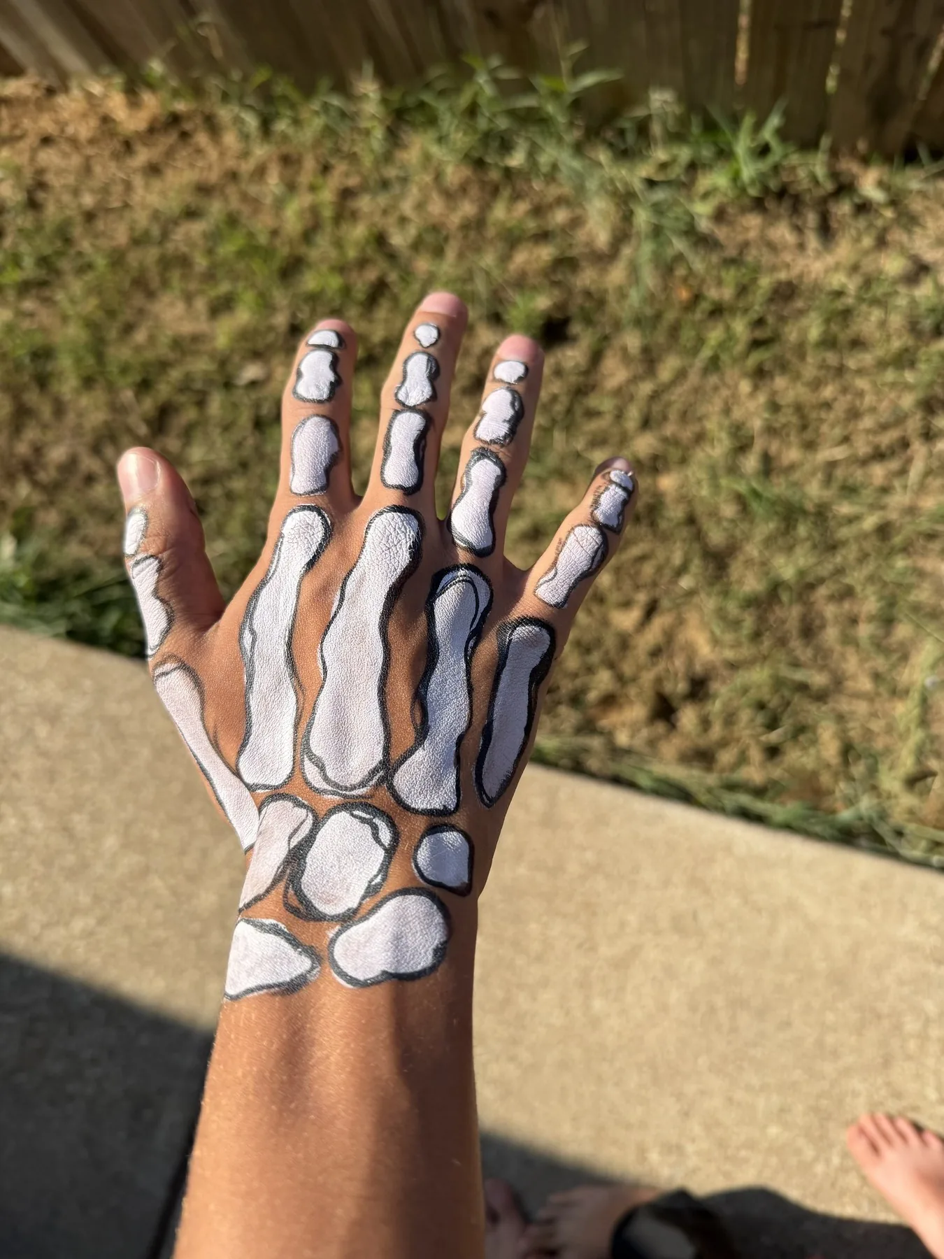 Black and white skeleton hand body painting for Halloween